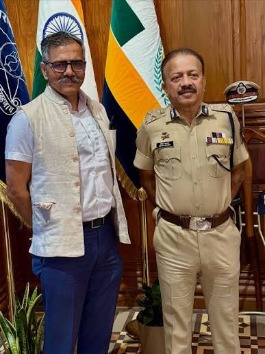 Deven Bharti in uniform standing beside a visitor at the office of the Commissioner of Police.