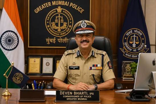 Deven Bharti, IPS, seated at the Commissioner of Police desk beneath the Greater Mumbai Police crest.