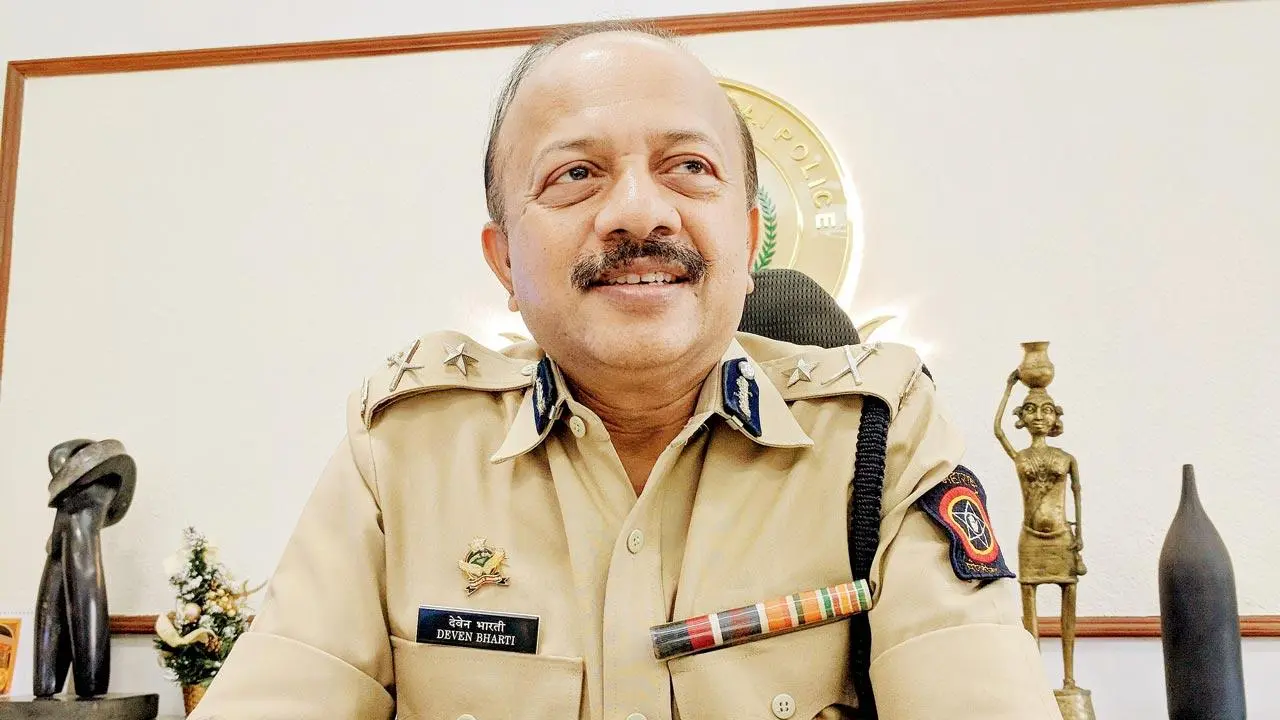 Deven Bharti in uniform at his desk in the Mumbai Police office, speaking during an interview.